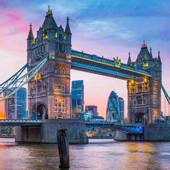 photo of london bridge over the Thames River in London at dusk.