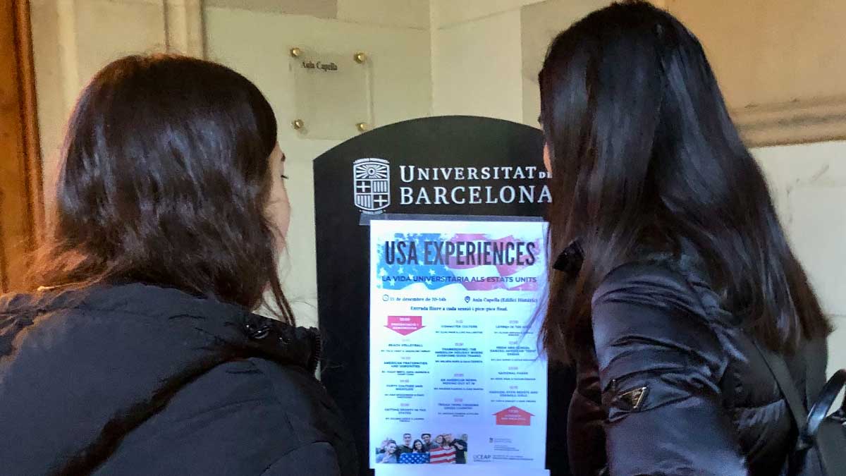 two students study a poster.